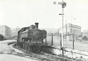 Ex-GWR 0-6-0 pannier tank, No. 9729, swings around the curve near Ashton Swing Bridge North signal box and heads towards Wapping along the New Cut with a freight train in 1960.